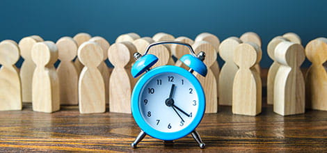 Wooden figures behind clock